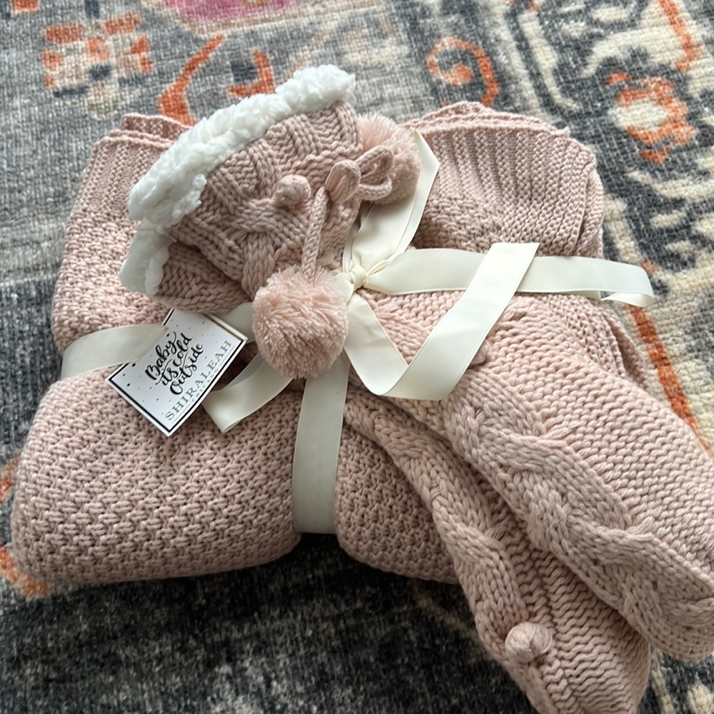 Blush color knit blanket and slipper bootie gift set.